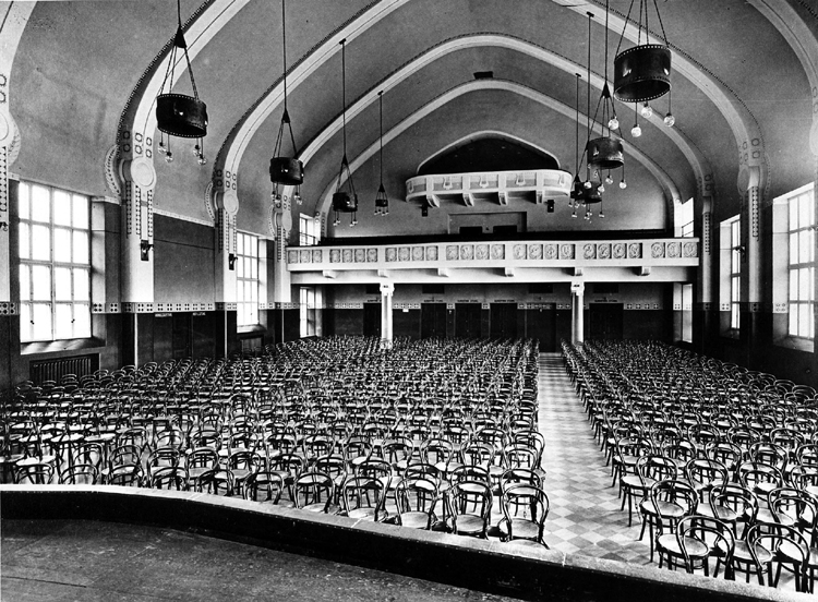 Black and white photograph showing a view of the hall from the stage to the back
