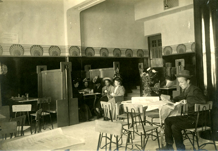 Sepia photograph showing the interior of Juttutupa with patrons.